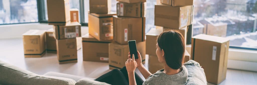 Woman on phone after packing boxes