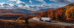 A moving truck winding through picturesque mountains and valleys in the hudson valley.